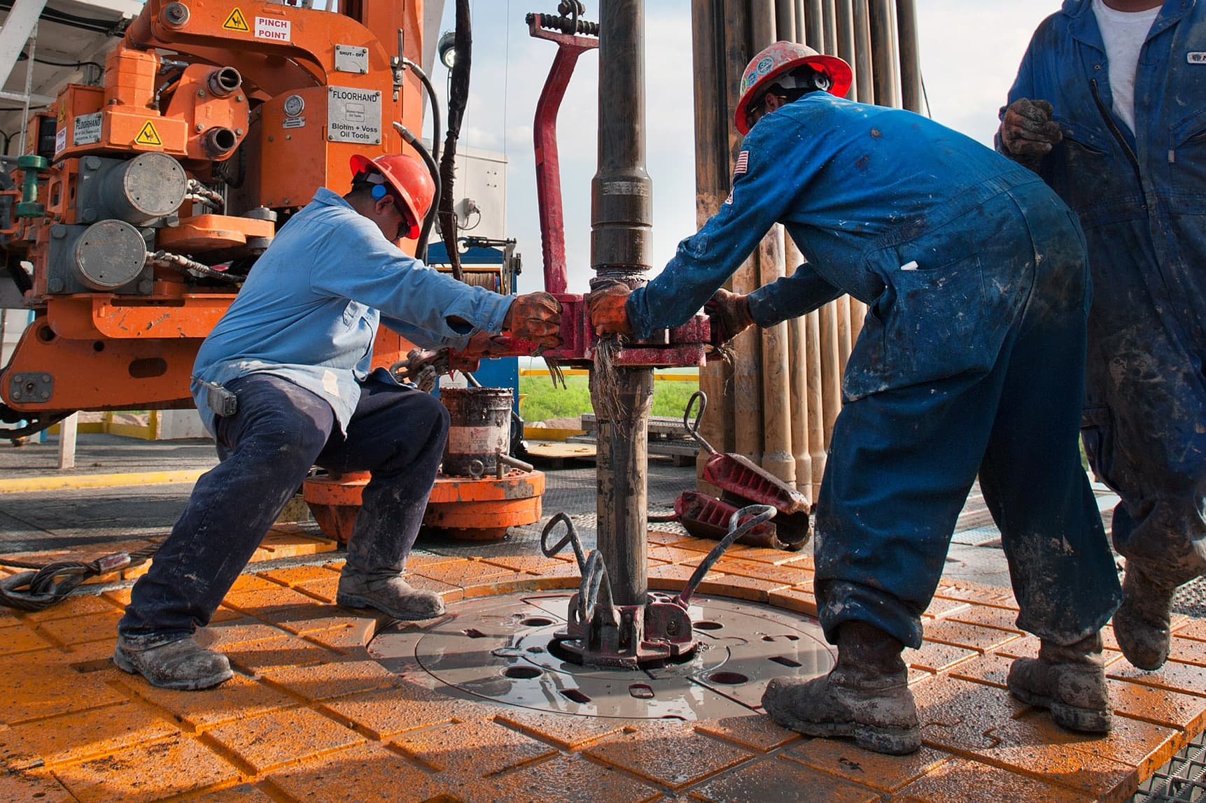 Oil and gas field workers performing maintenance